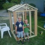 Young boys building a shed